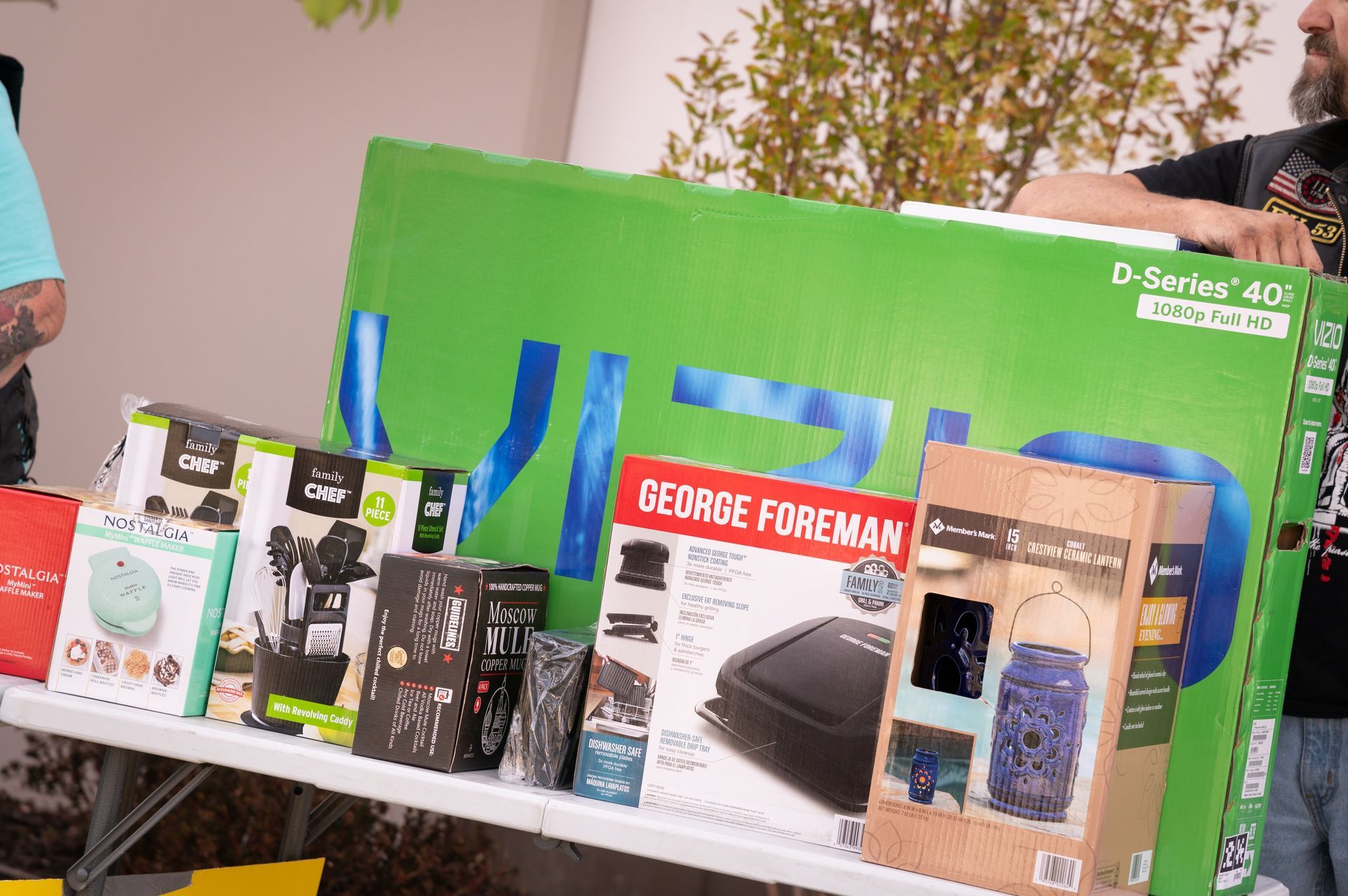 A man is holding a large green box that says george foreman