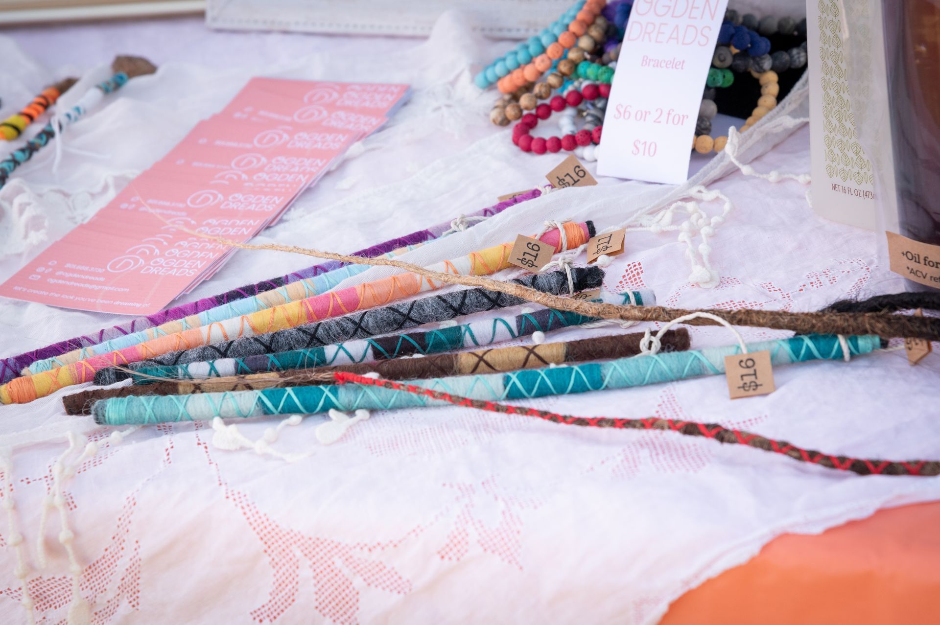A table topped with a bunch of colorful sticks and beads.