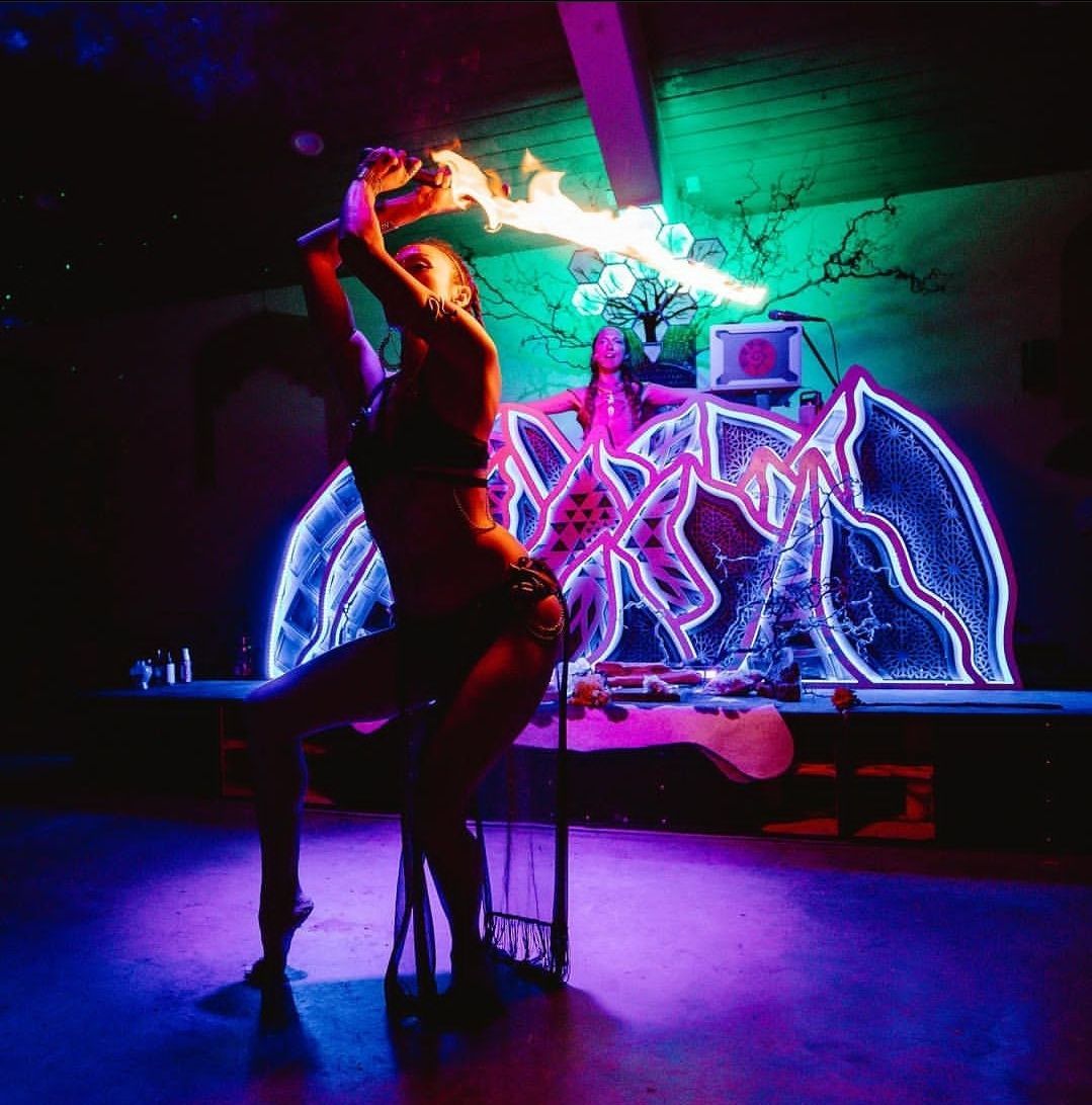 A woman in a bikini is holding a fire torch