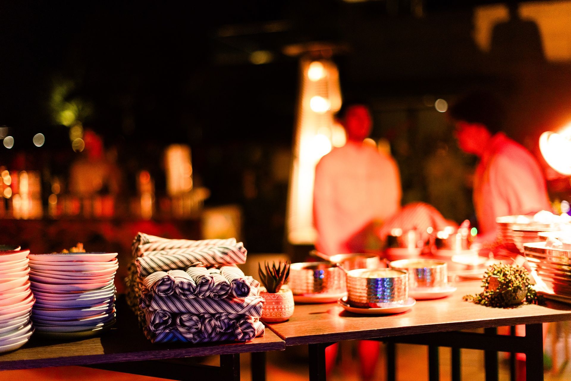 A table with plates and cups on it in a restaurant.