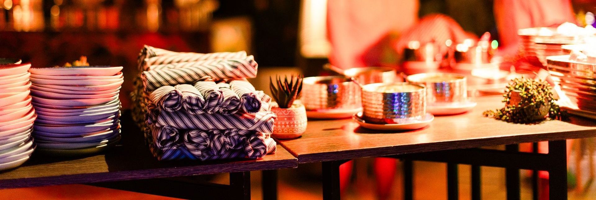 A table with plates , cups , and napkins on it.