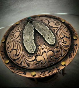 A copper plate with two feathers on it