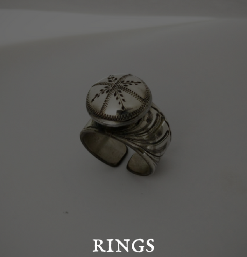 A silver ring with the word rings below it