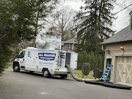 A white van is parked in front of a house.