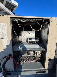 The inside of a building air conditioner with the door open.