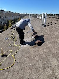 A man is working on the roof of a building.