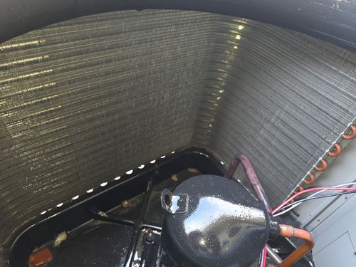 A close up of a blue machine with a red button on it