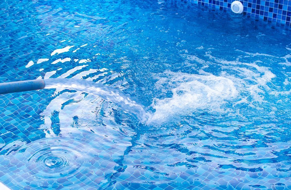 A Water Spraying Into a Blue Tiled Swimming Pool — Cascade Pool & Spa Centre in South West Rocks, NSW