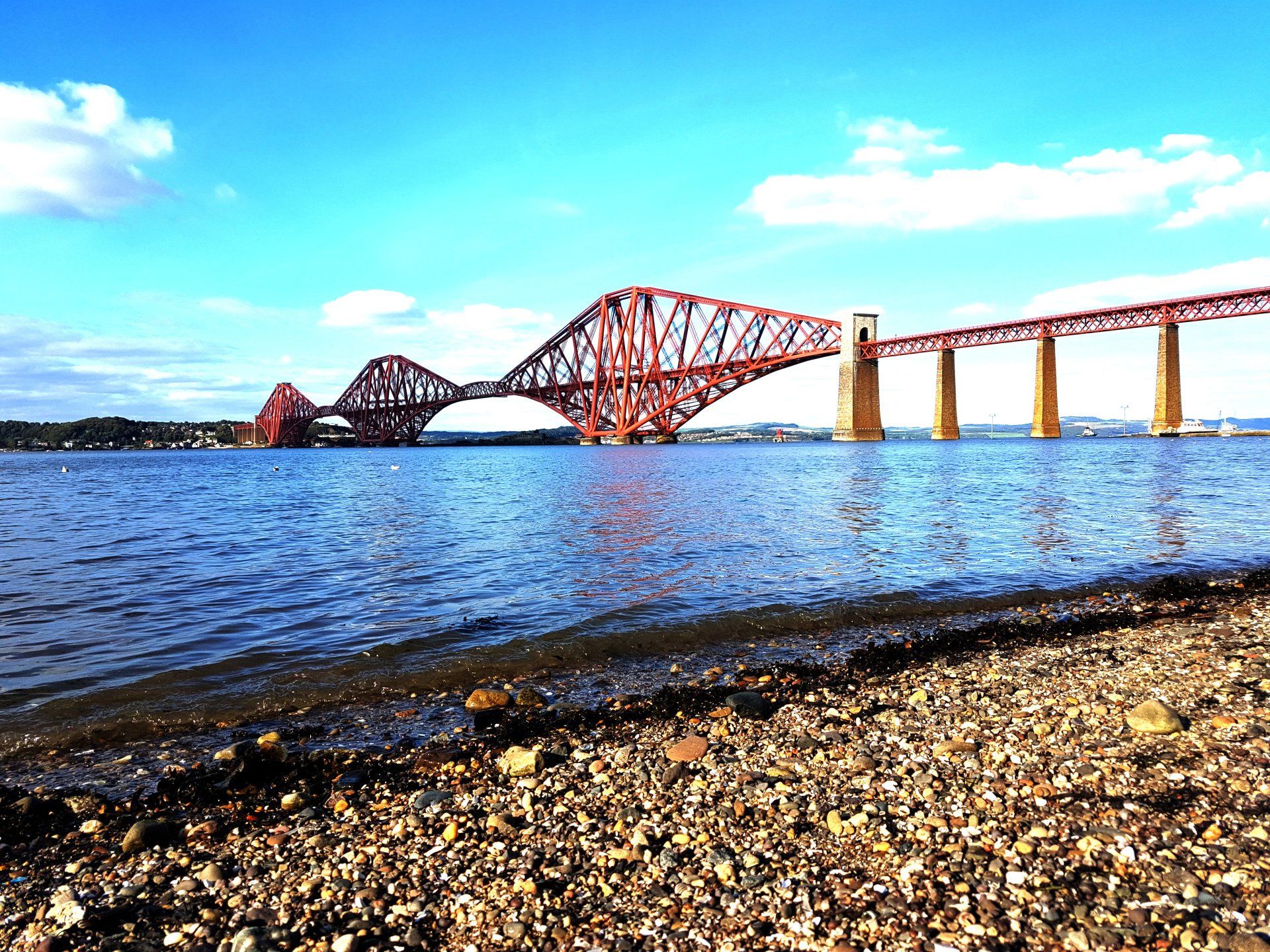 Iconic Forth Bridge spanning the Firth of Forth in Scotland, showcasing its intricate cantilever des