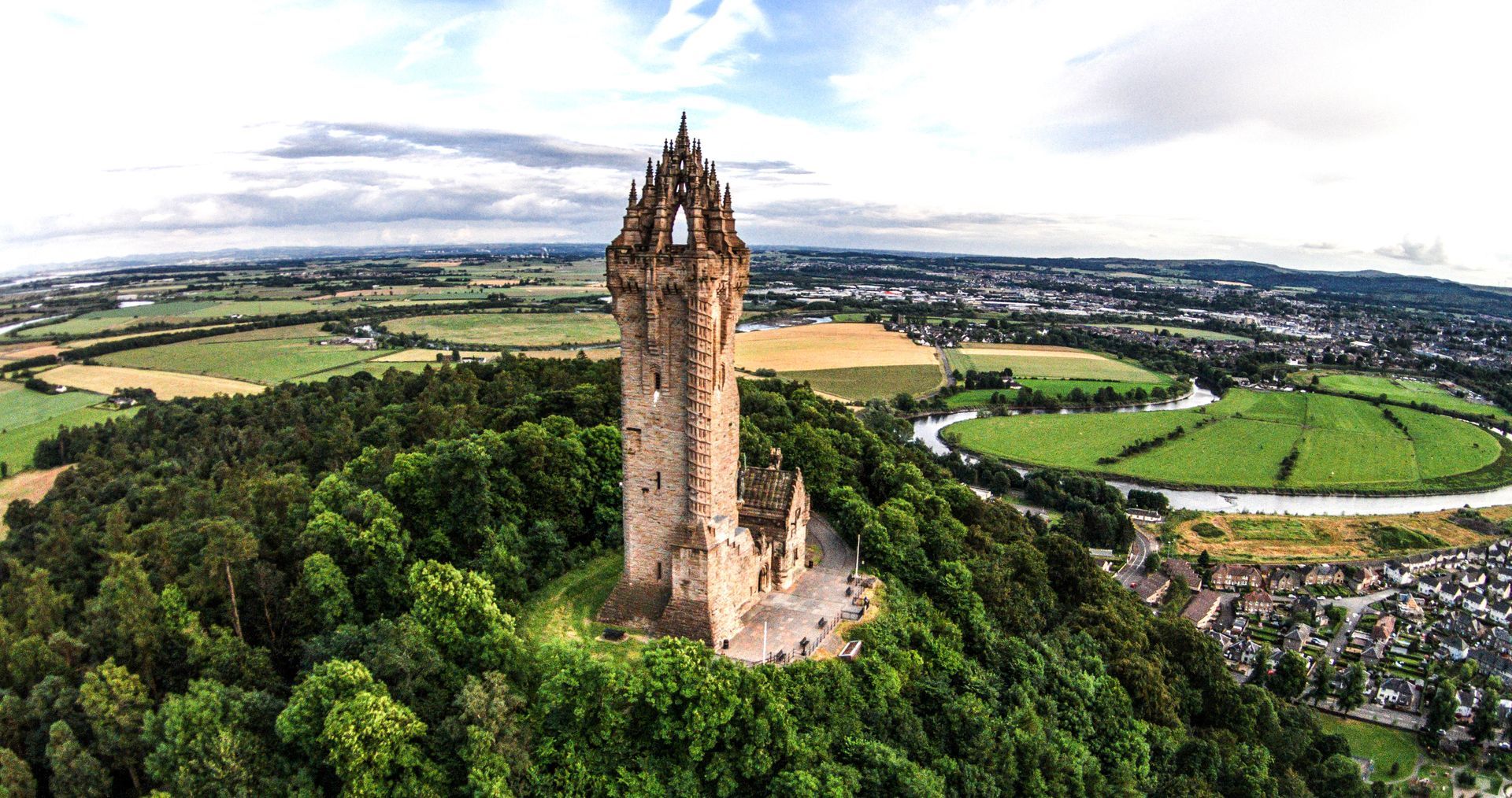 William Wallace Monument standing tall on Abbey Craig, overlooking the city of Stirling and the scen