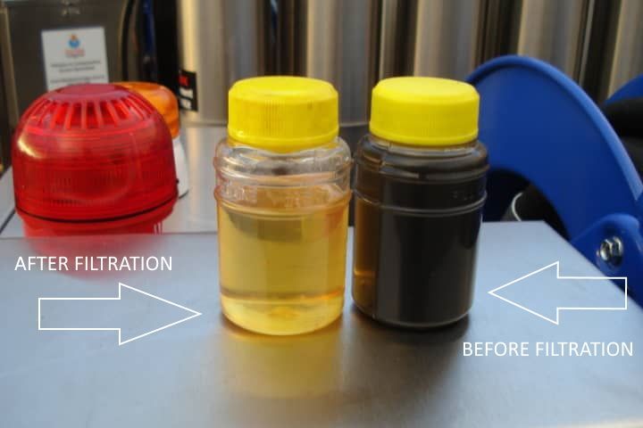Two bottles of different colored liquids are sitting on a table.