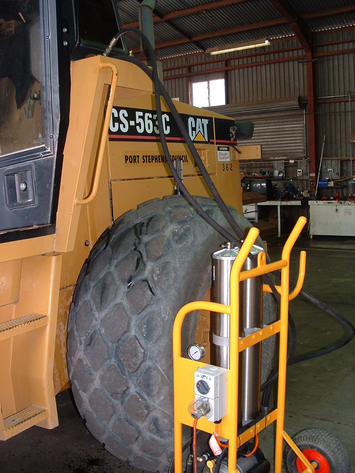 A large tire is attached to the back of a cs-565c cat tractor