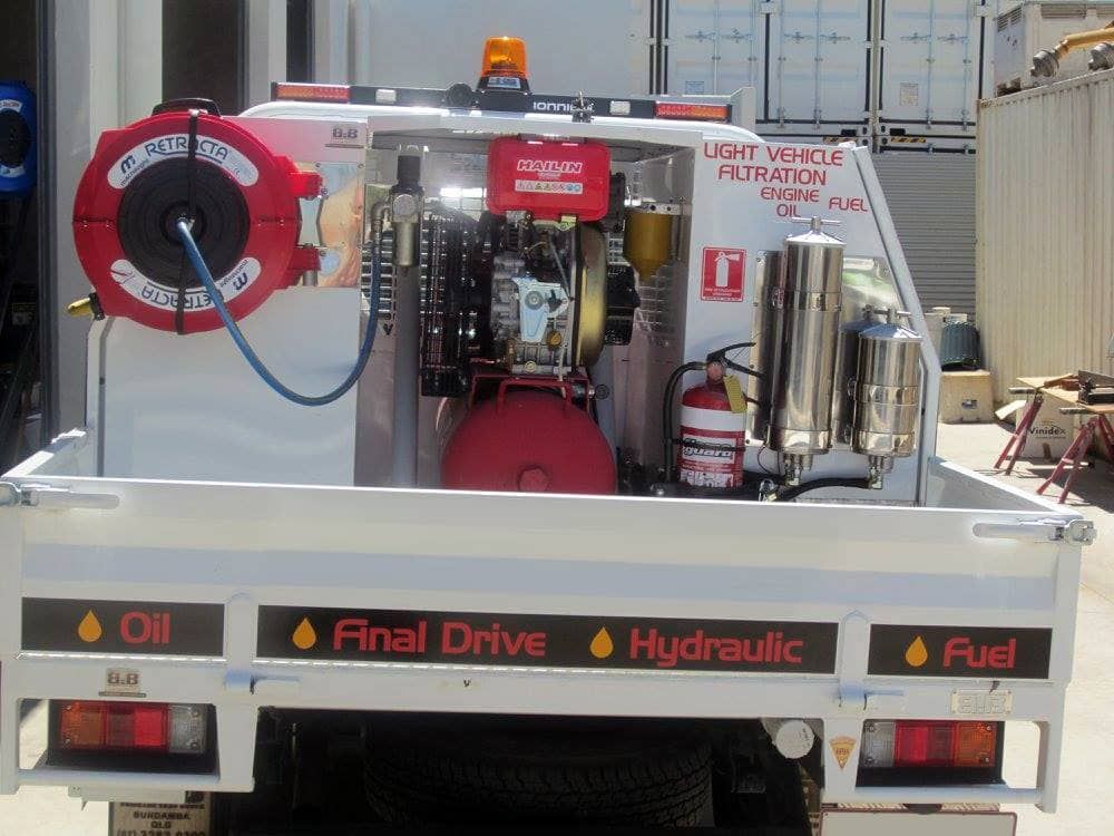A white truck with a red hose attached to it that says final drive