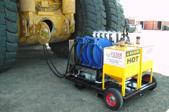 A machine that says filter hot is attached to a truck