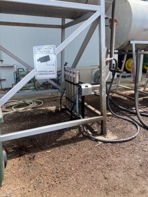 A metal structure with a sign on it that says ' security camera '