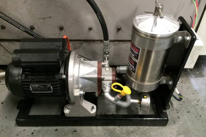 A stainless steel pump with a motor attached to it