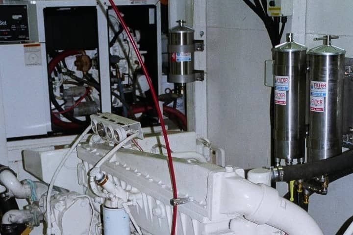 A white engine is sitting in a room on a boat