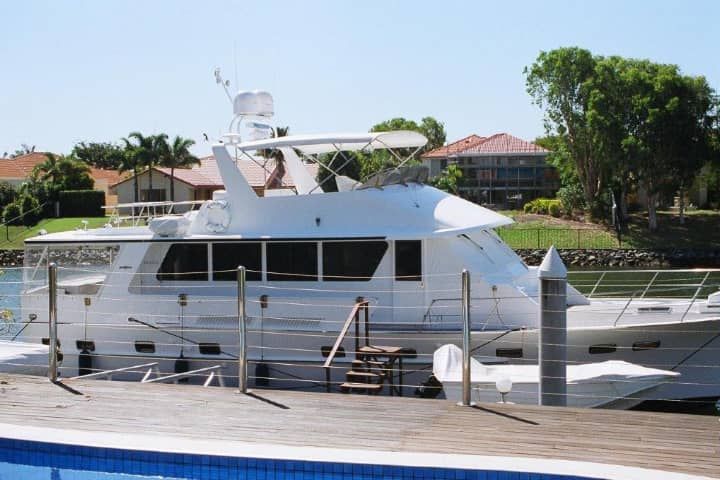 A large white boat is docked next to a swimming pool