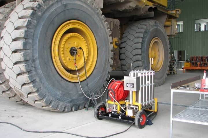 A large tire is being checked by a machine