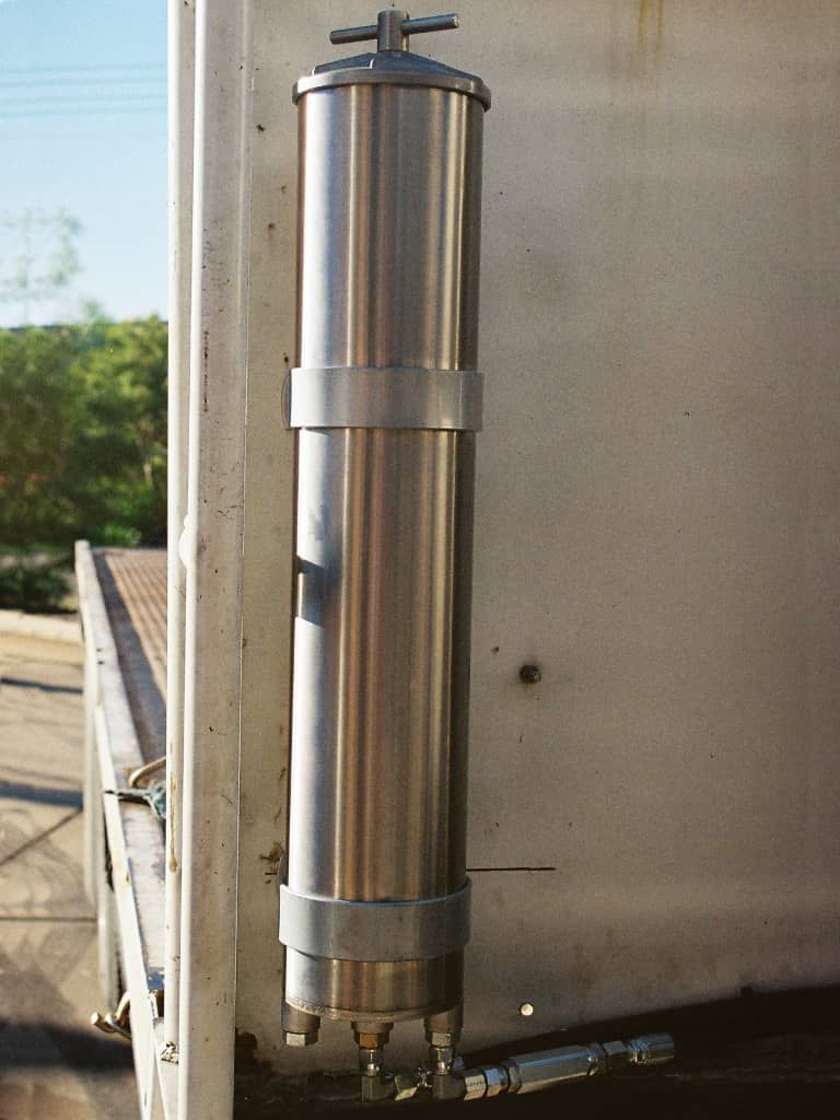 A stainless steel pipe is attached to a wall