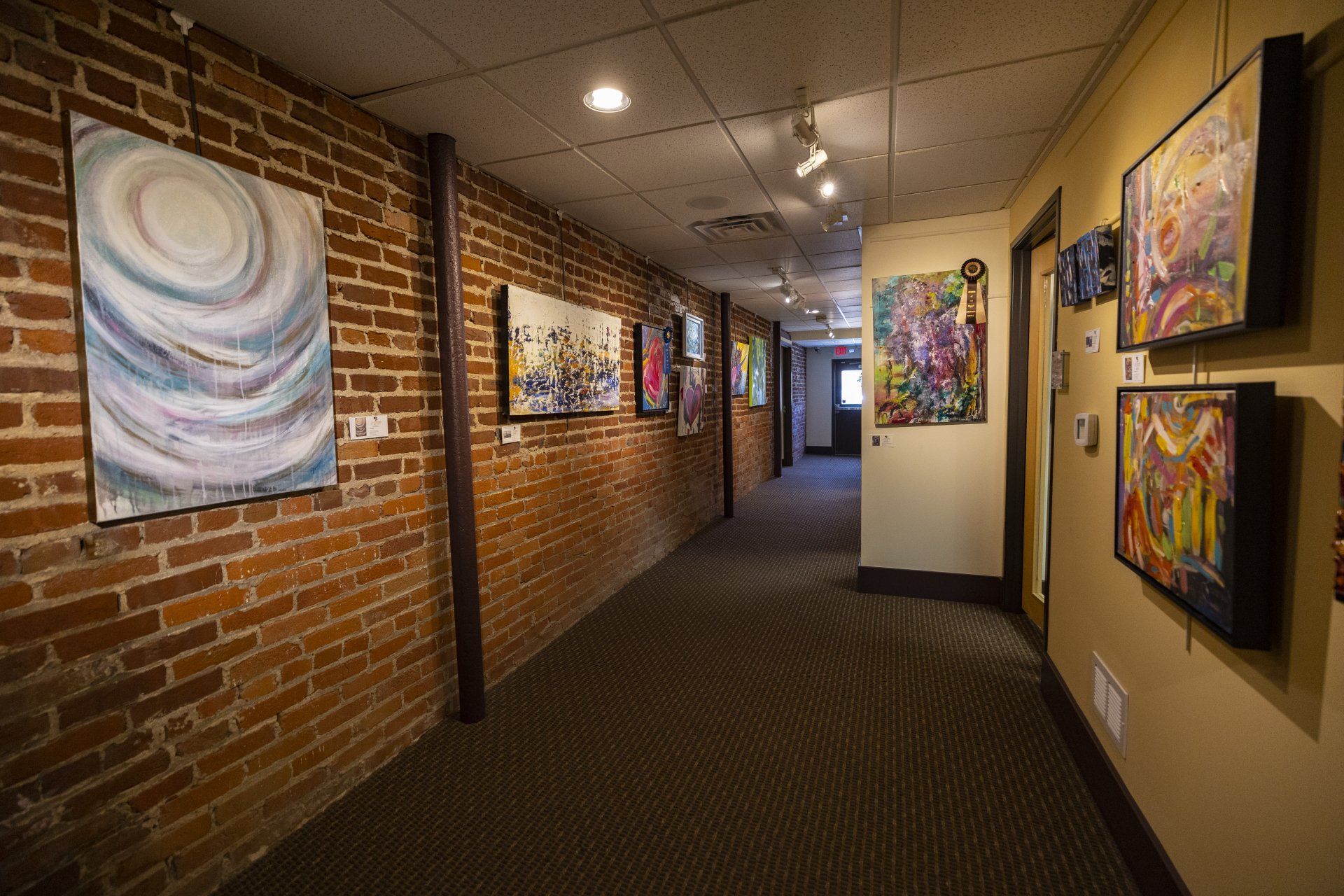 buttonwood hallway lined with art