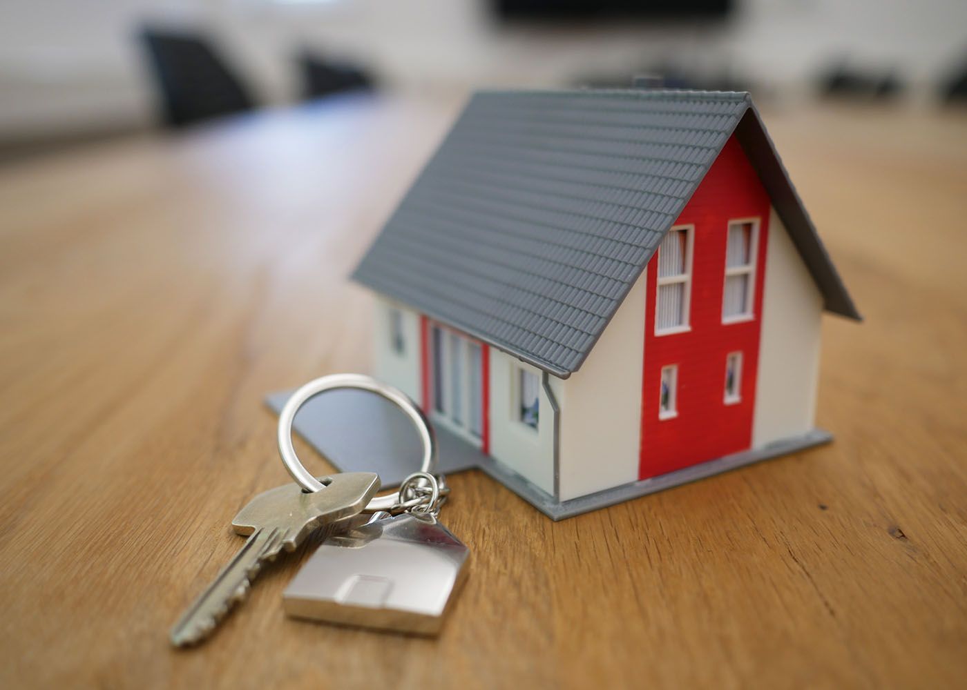 Key on a keychain and a small model home 