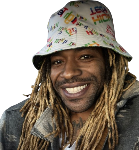 Man with blonde dreadlocks and a colorful bucket hat smiling.