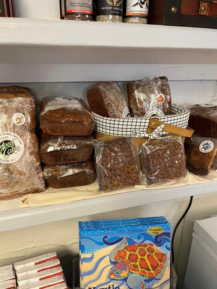 A shelf filled with lots of bread and a box of turtles.
