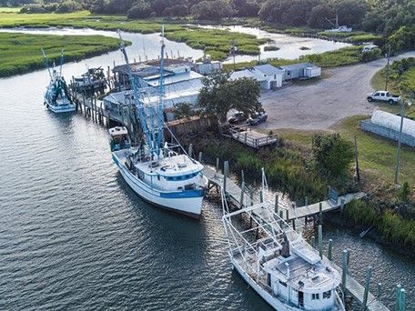 An aerial view of a dock with boats docked in the water.