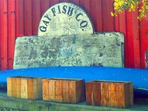 A wooden bench with a sign that says gay fish co.