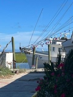 A boat is docked at a dock next to a house.