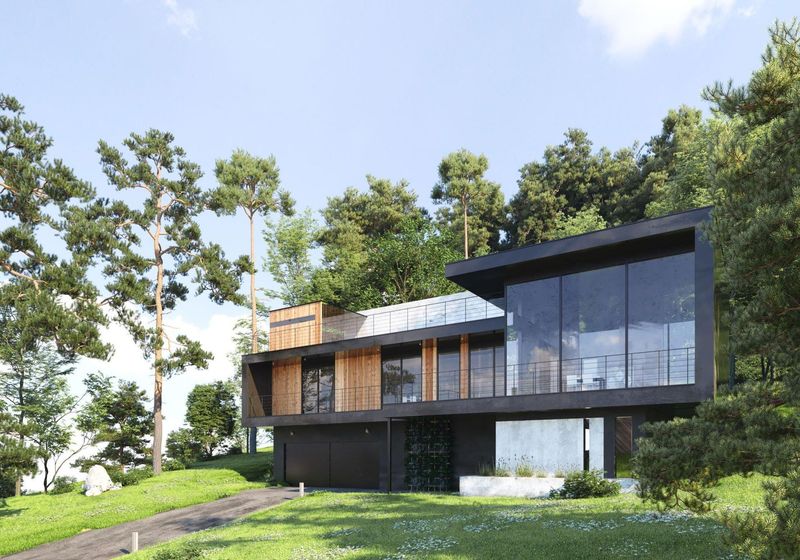 A large house with a lot of windows is surrounded by trees and grass.