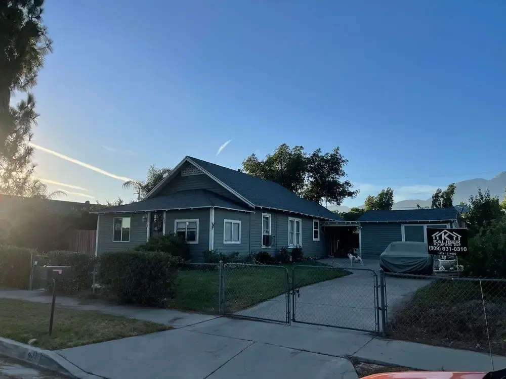 A house with a sign that says ' for sale ' on it