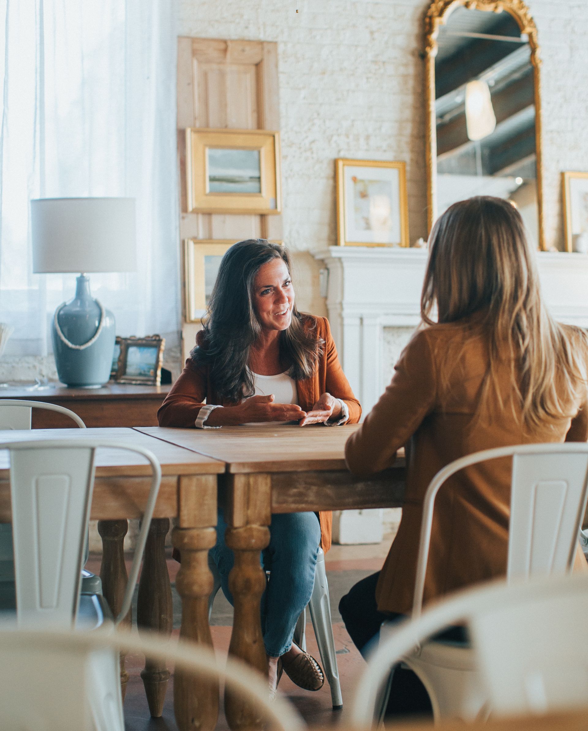 Kamille Gannett speaking to a client in a beautiful office