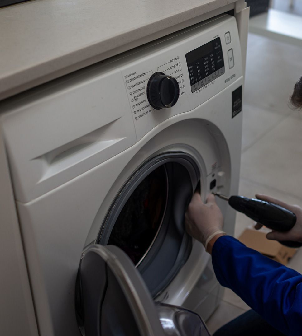 Worker Repairing Washing Machine — Coral Springs, FL — Central Appliance Repair LLC