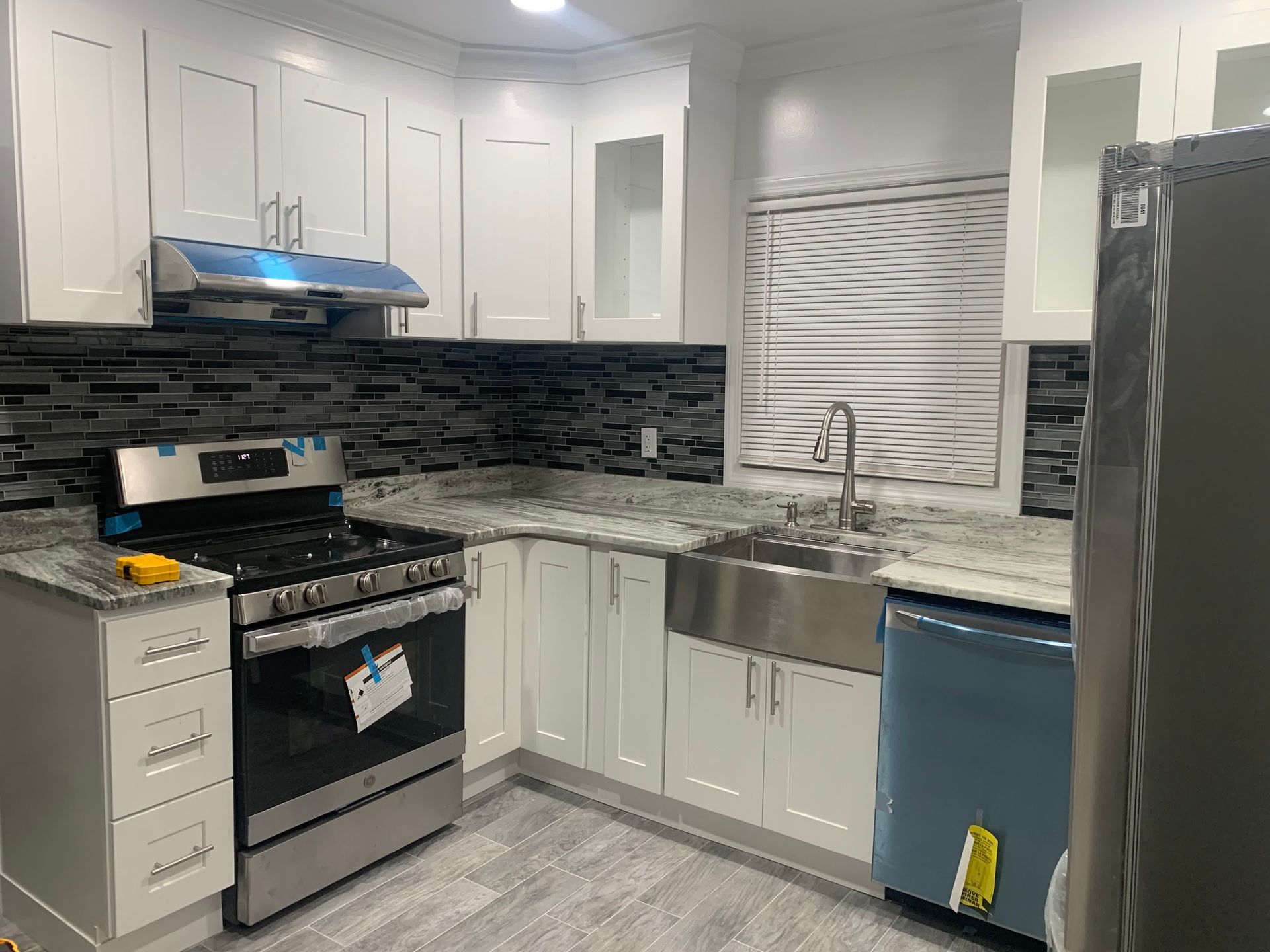 a modern kitchen with black cabinets , wooden counter tops and stools .