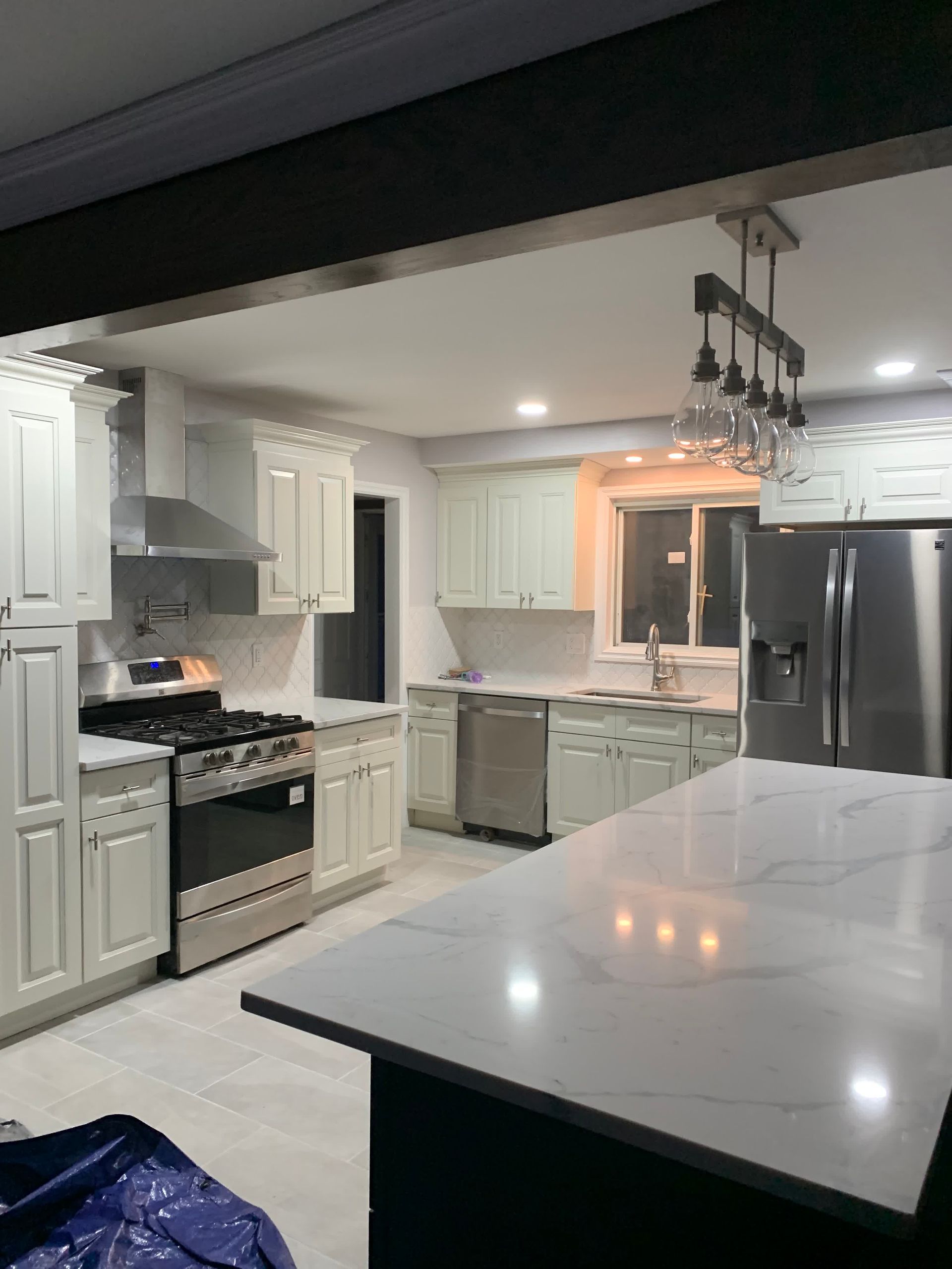 a kitchen under construction with a large island in the middle of the room .