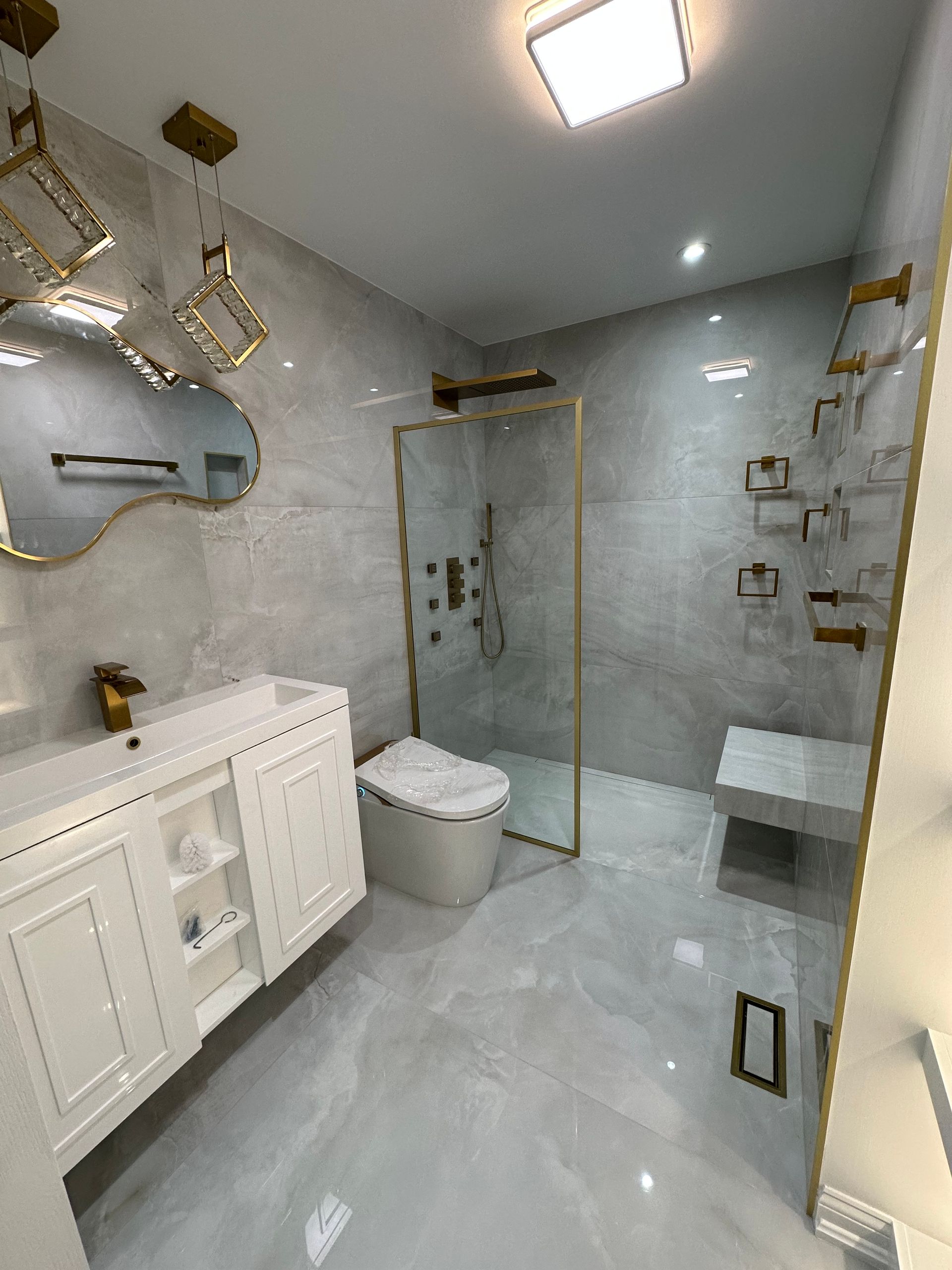 a man is installing tiles on a wall in a bathroom .