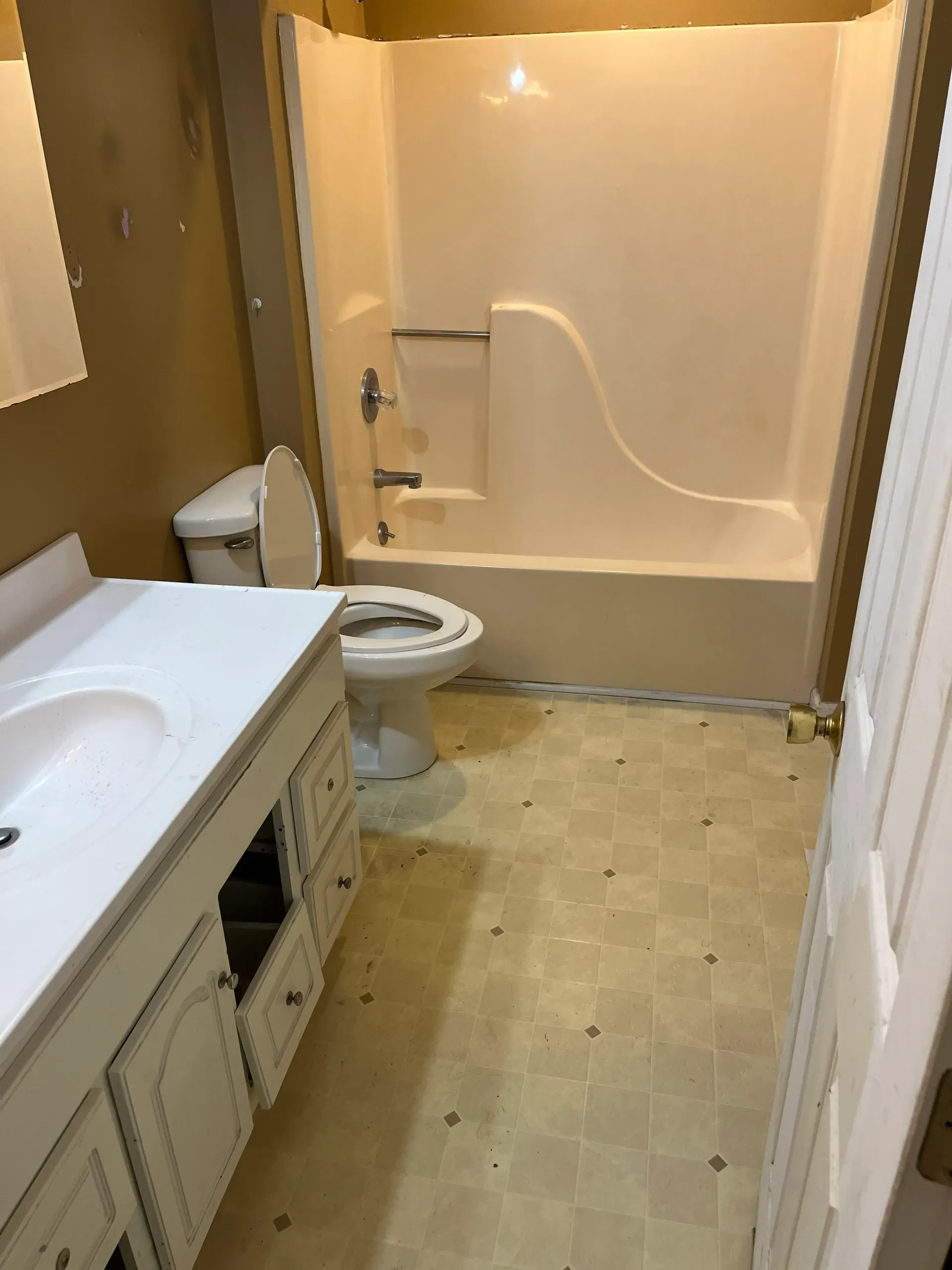 A bathroom with a toilet , sink , and bathtub.