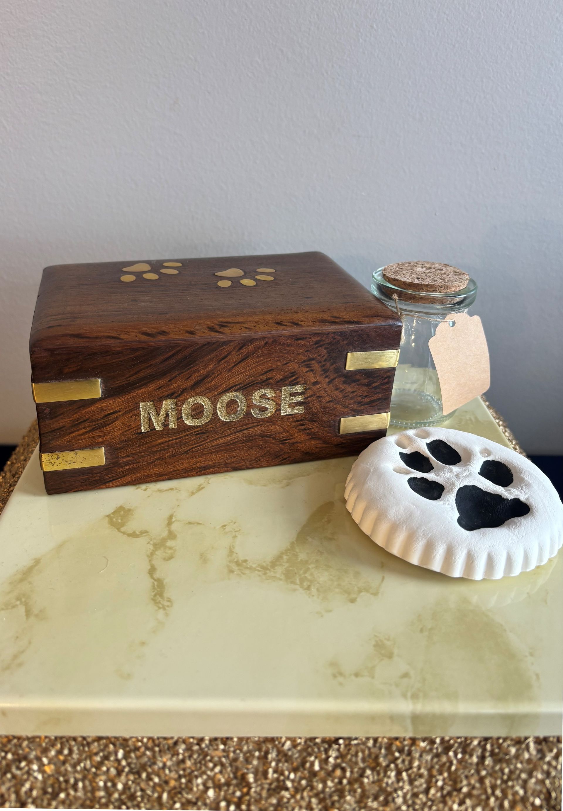 Three wooden boxes with locks and flowers on a table.