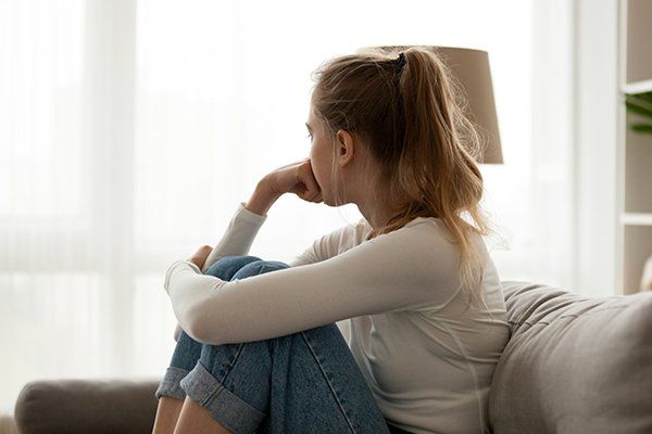 Upset Woman Sitting on Couch — North Salt Lake, UT — Lifeline for Youth