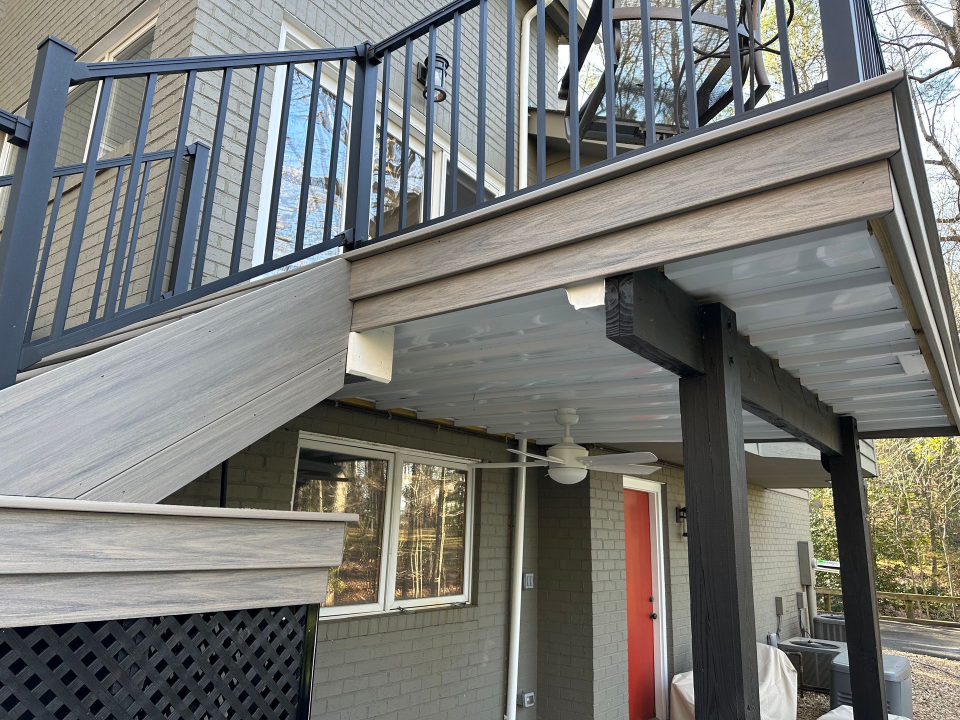A house with a balcony and stairs leading up to it.