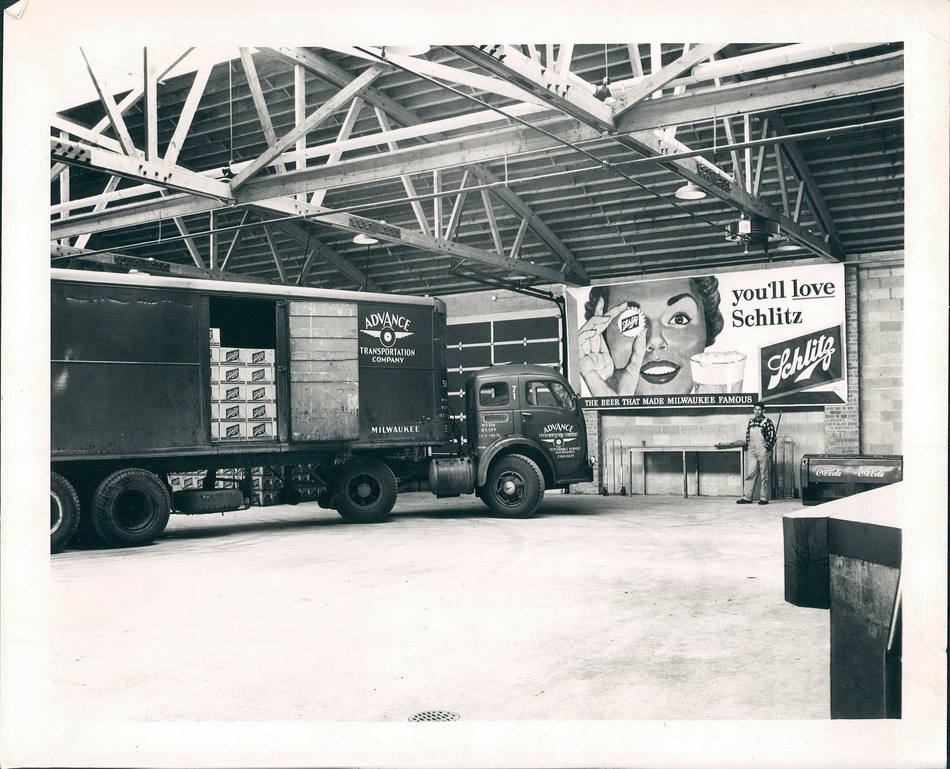 A black and white photo of a truck in a warehouse