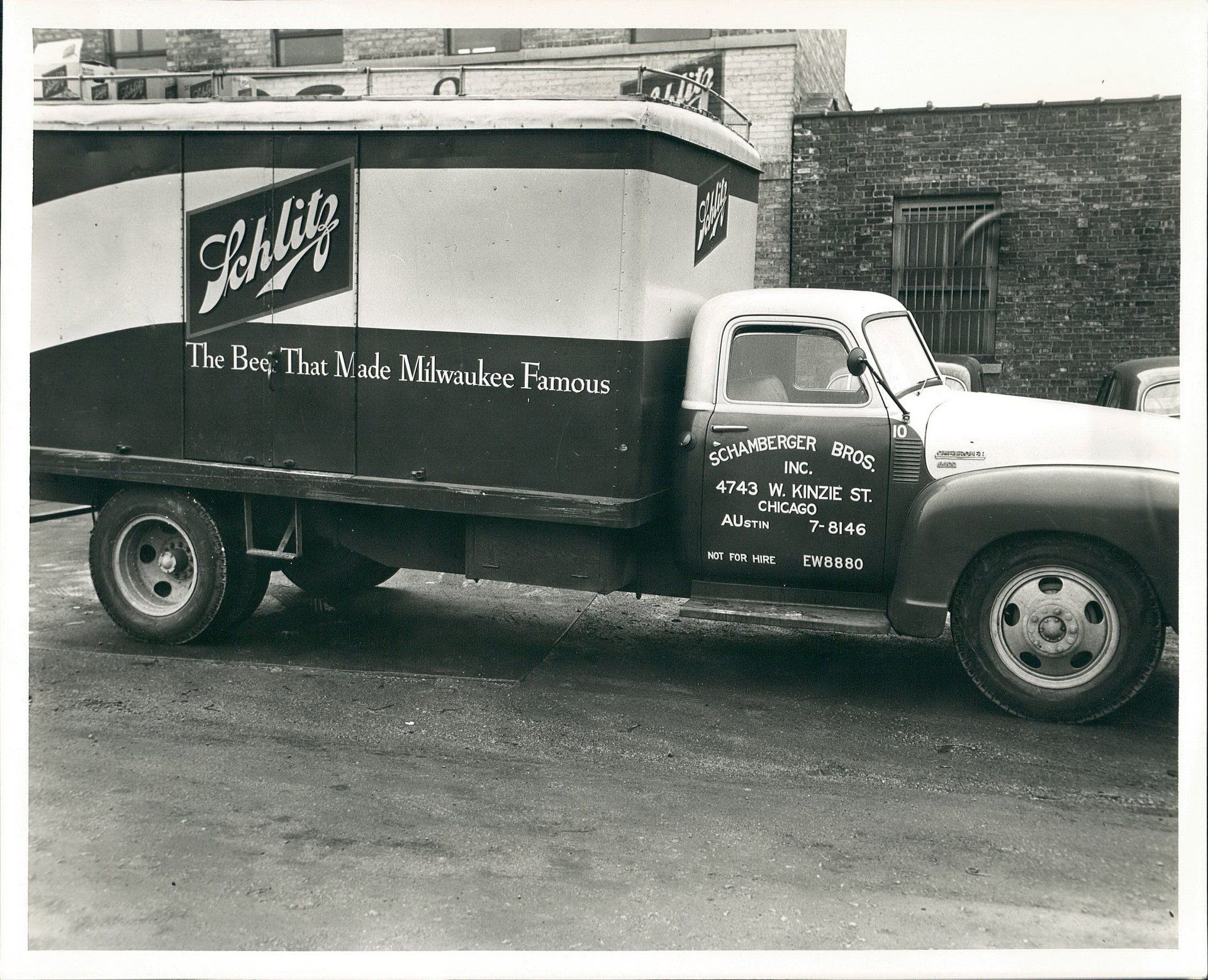 A black and white photo of a schultz truck