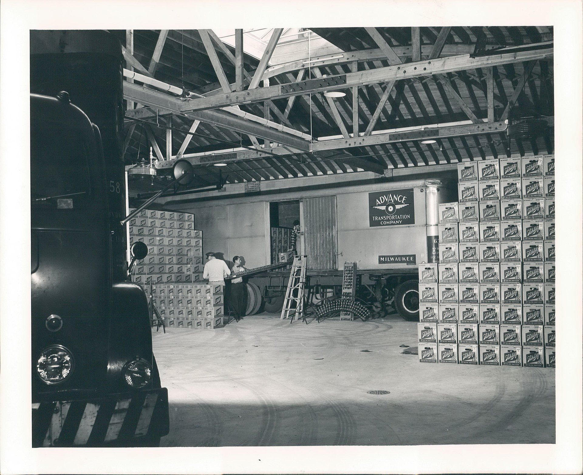 A black and white photo of a warehouse full of boxes