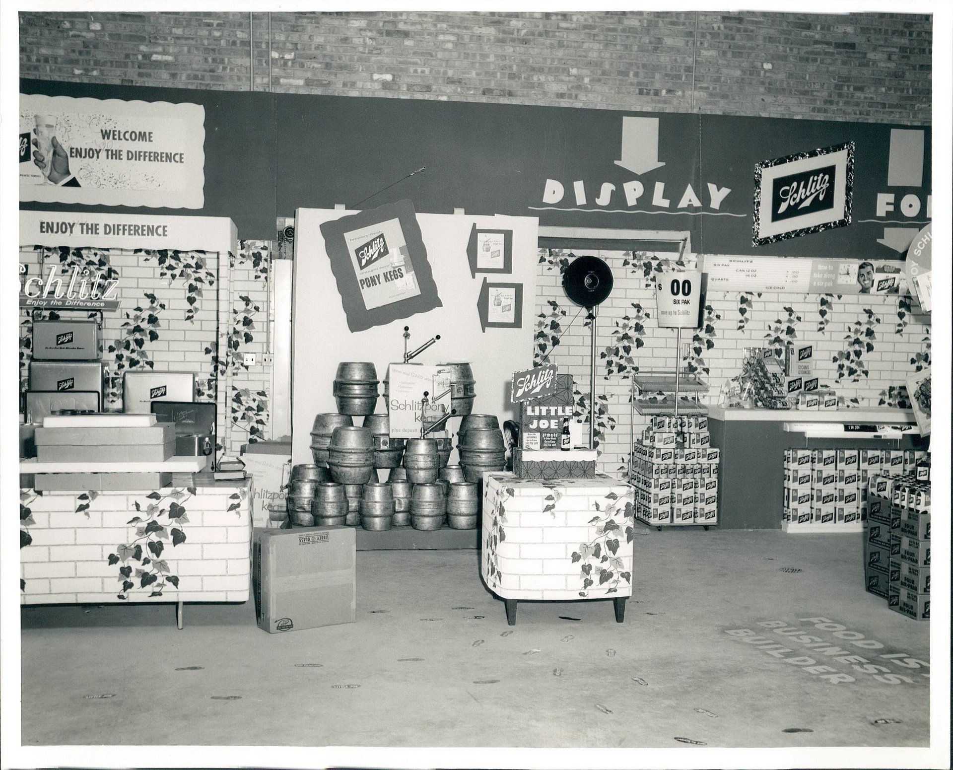 A black and white photo of a store with a sign that says display