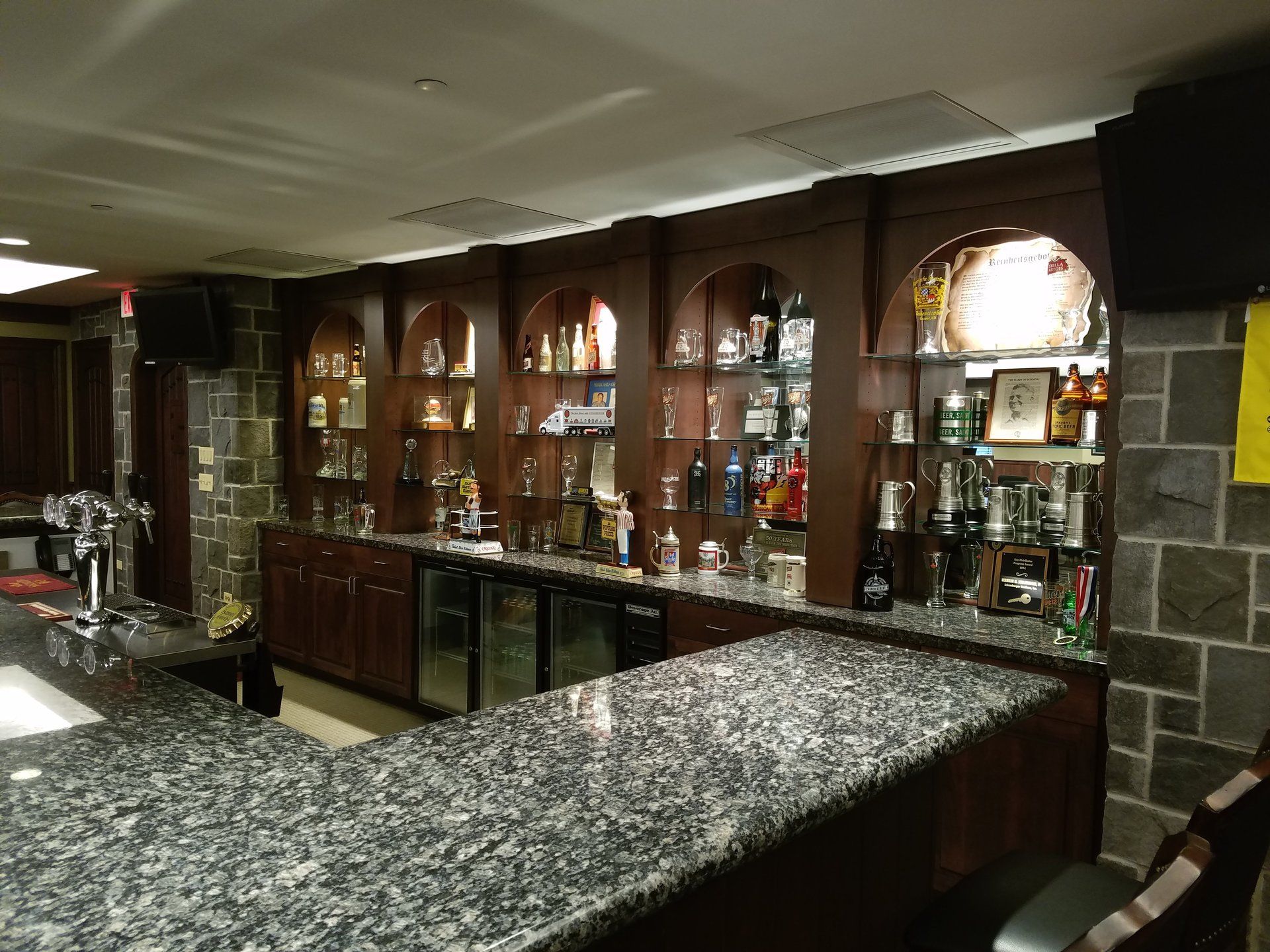 A bar with a lot of bottles on the shelves