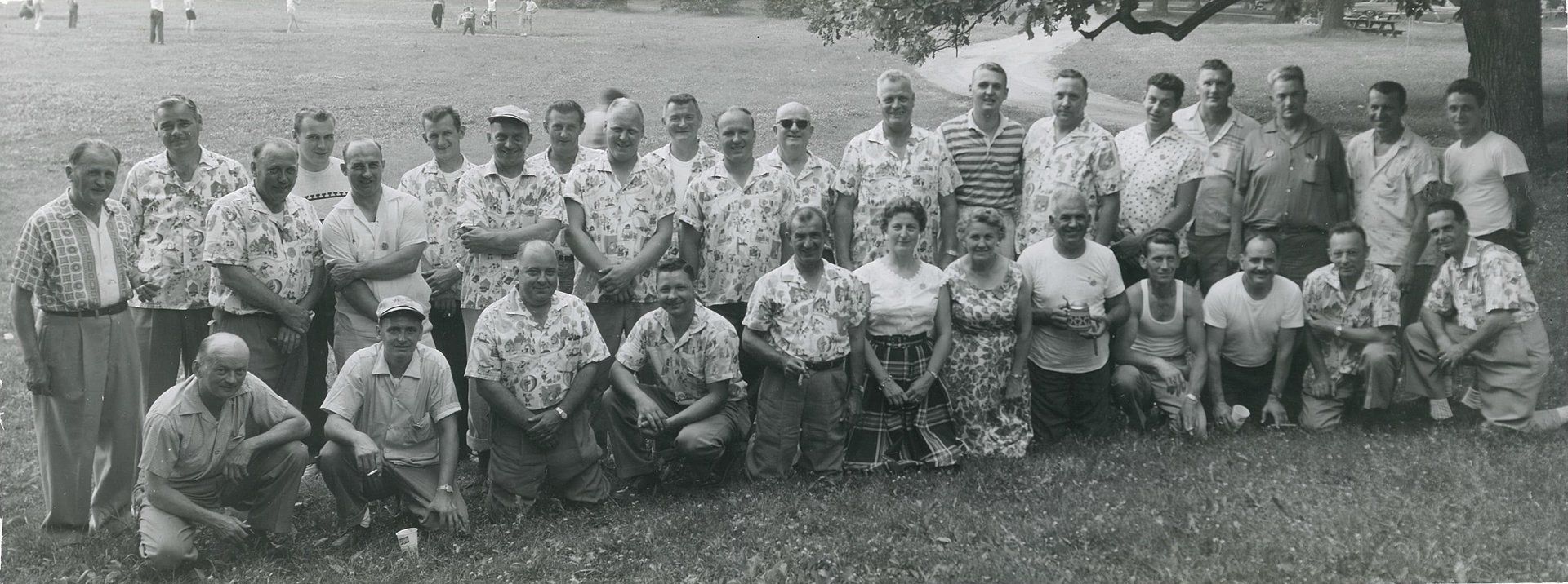 A black and white photo of a group of people posing for a picture