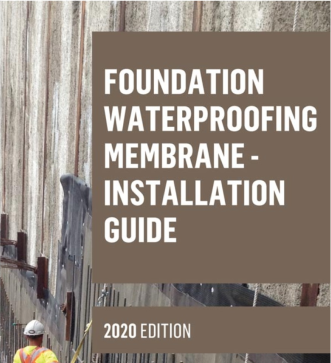 A construction worker stands by a concrete foundation wall next to a guide titled 