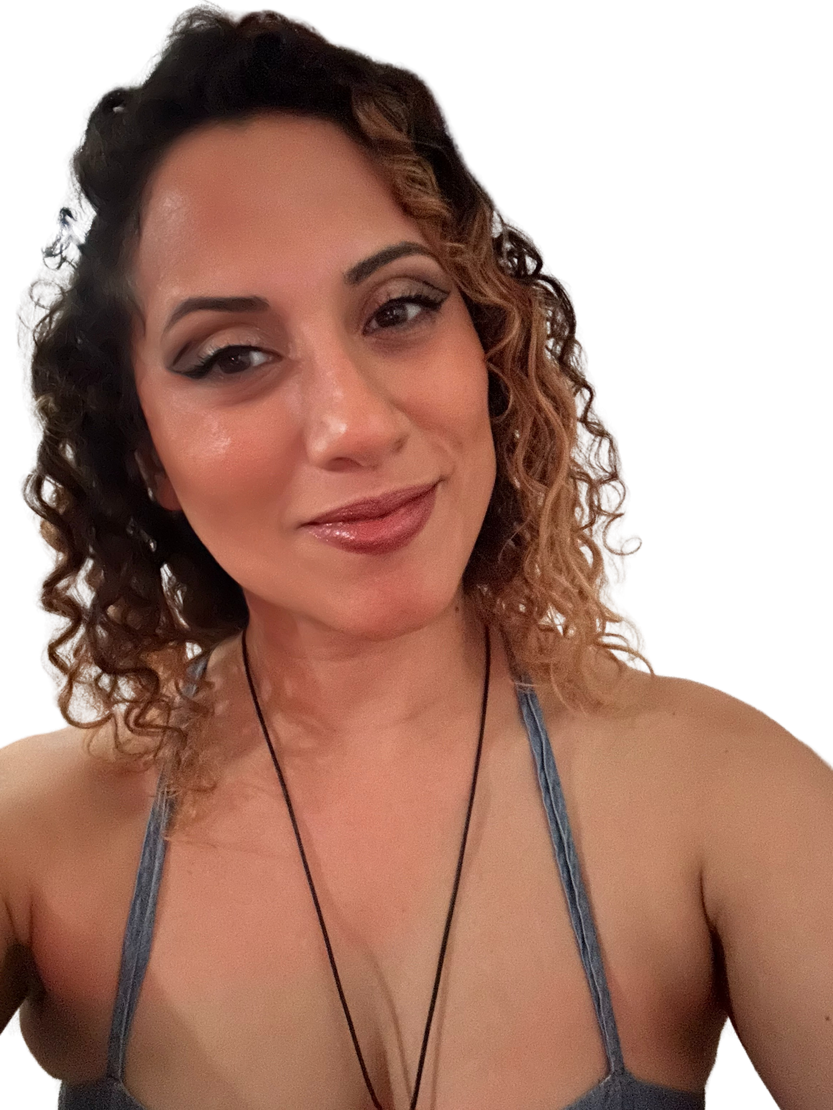 A woman with curly hair is wearing a necklace.